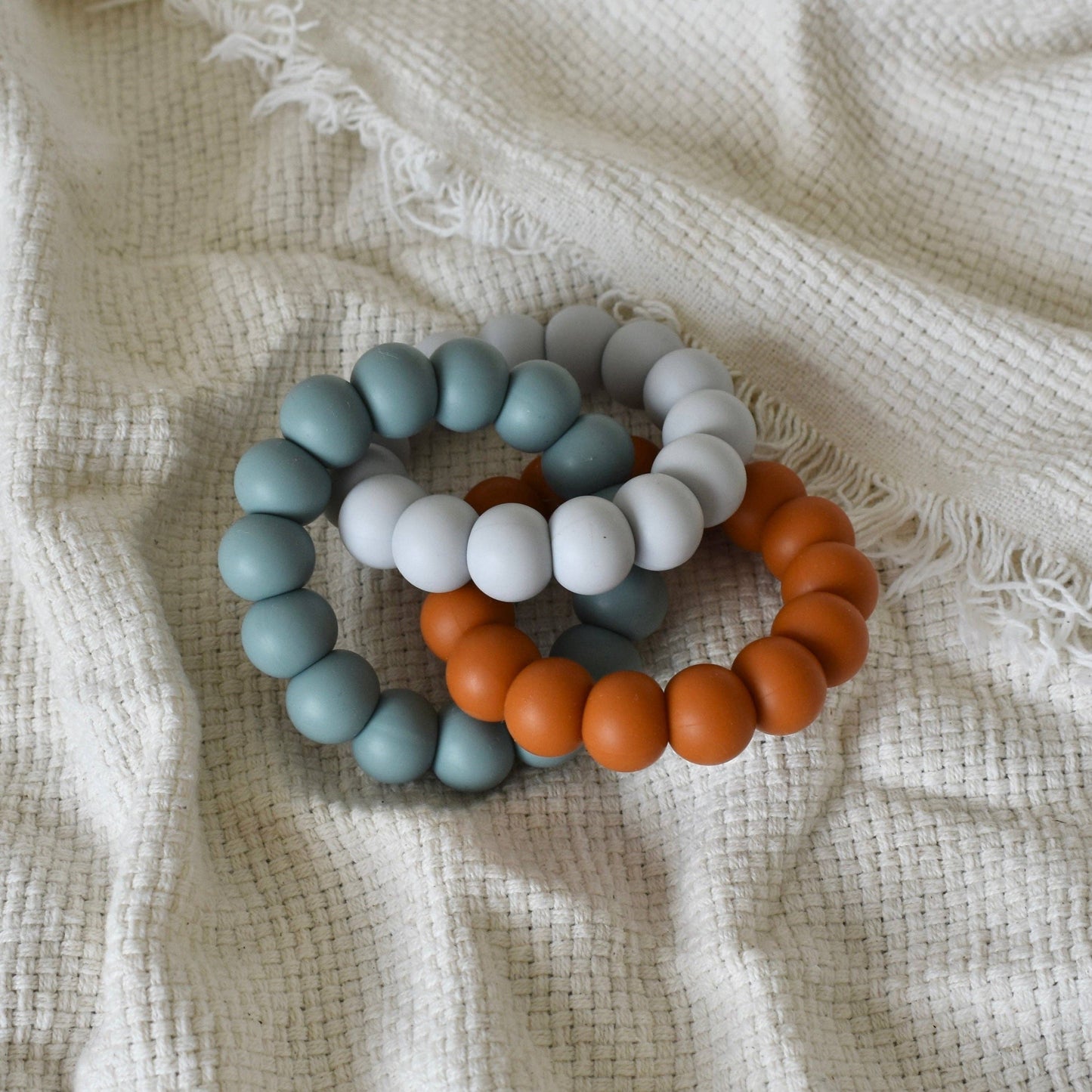 Trio Teether - Pale Grey/Petrol/Rust