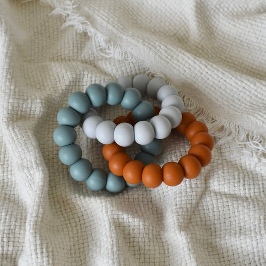 Trio Teether - Pale Grey/Petrol/Rust